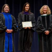Christine, Faculty, Provost posing with award